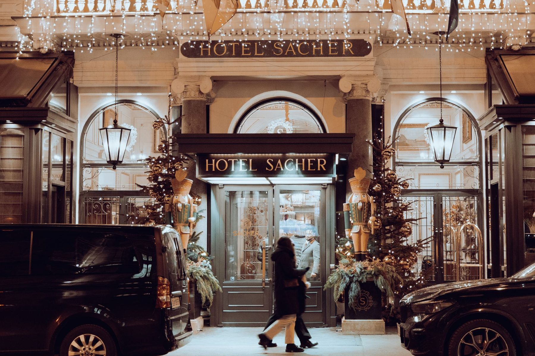 Grand hotel entrance illuminated at night